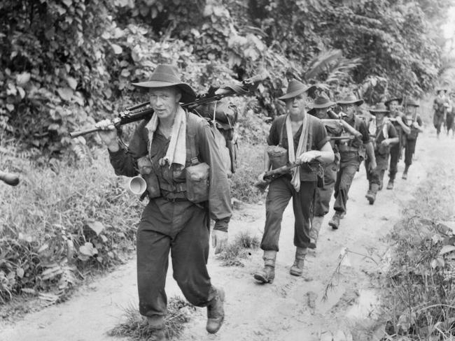 Australian Troops of D company, 35th Infantry Battalion, move along a road near Madang, Papua New Guinea.