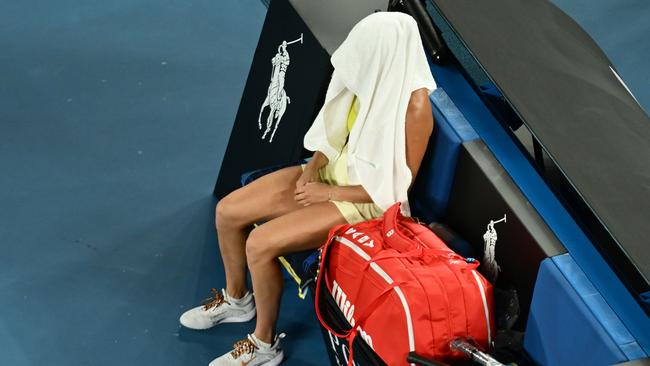 Sabalenka covered her face from the crowd and cameras with a towel. Picture: Hannah Peters/Getty Images