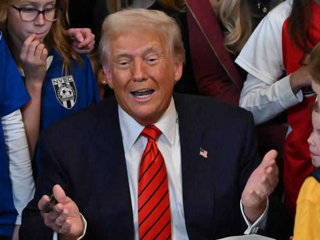 US President Donald Trump speaks as he signs the No Men in Women's Sports Executive Order into law in the East Room of the White House in Washington, DC, on February 5, 2025. President Trump on Wednesday is signing an executive order to ban transgender girls and women from competing on sports teams that match their gender identity, marking his latest move targeting transgender rights. (Photo by ANDREW CABALLERO-REYNOLDS / AFP)