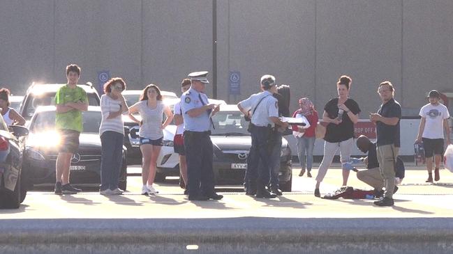 Police speak with a woman and other bystanders at Eastgardens on Bunnerong Rd, Maroubra, on Monday. Picture: TNV