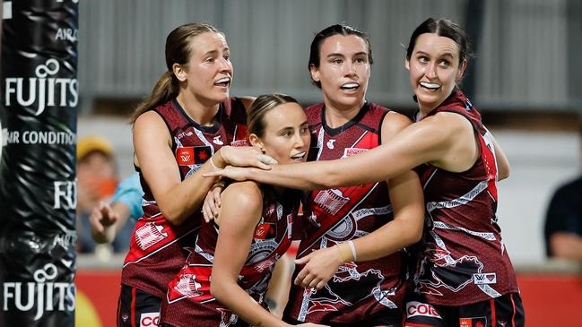 DARWIN, AUSTRALIA - OCTOBER 26: Georgia Gee of the Bombers celebrates a goal with teammates during the 2024 AFLW Round 09 match between the Essendon Bombers and the Richmond Tigers at TIO Stadium on October 26, 2024 in Darwin, Australia. (Photo by Dylan Burns/AFL Photos via Getty Images)