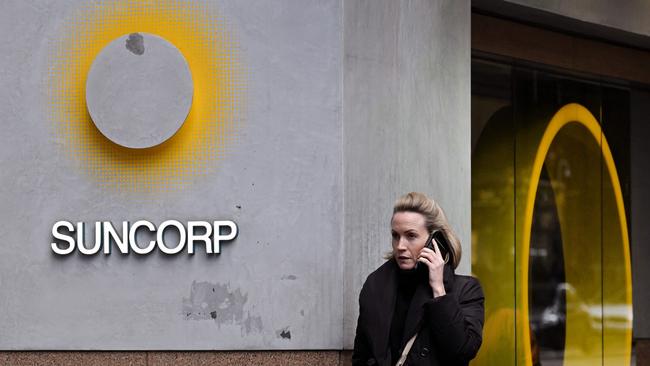 A pedestrian walks past a Suncorp Bank branch in Melbourne on July 18, 2022. - Australian banking giant ANZ announced on July 18 a 3.3 billion USD deal to swallow regional lender Suncorp Bank -- one of the biggest takeovers in the sector for more than a decade. (Photo by William WEST / AFP)