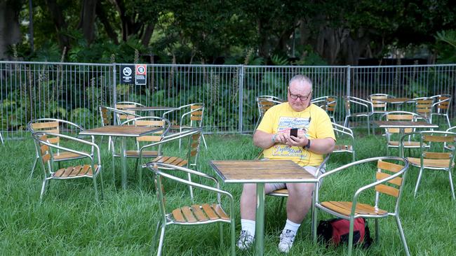 A man sitting by himself among a sea of empty chairs. Picture: Damian Shaw