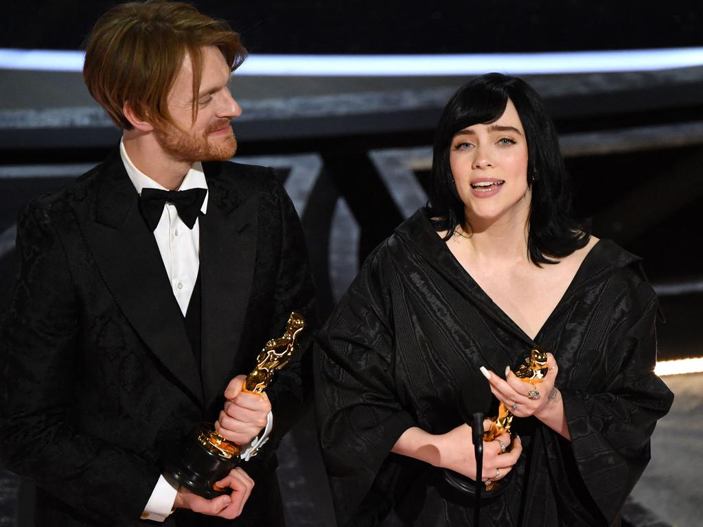 US singer-songwriter Finneas O'Connell and singer-songwriter Billie Eilish accept the award for Best Music (Original Song) for "No Time to Die". Picture: Robyn Beck / AFP