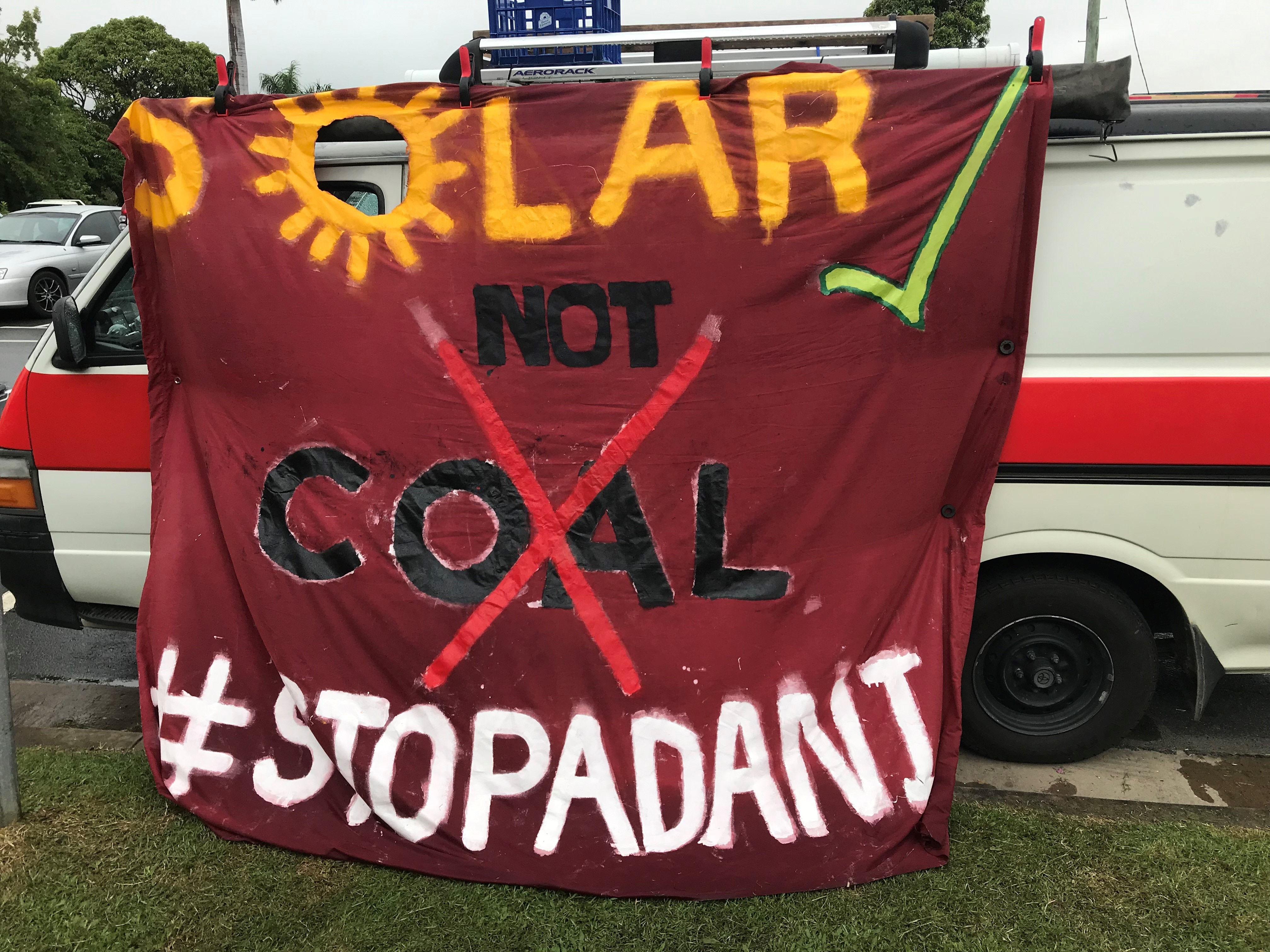 Anti-Adani protestors adorn a car with a solar future message.