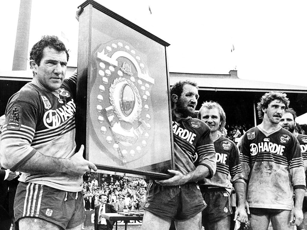 Parramatta players (L-R) Mick Cronin, Ray Price holding JJ Giltinan Shield, Peter Sterling &amp; Brett Kenny after a try-less grand final win over the Bulldogs in 1986. Picture: Peter Kurnik