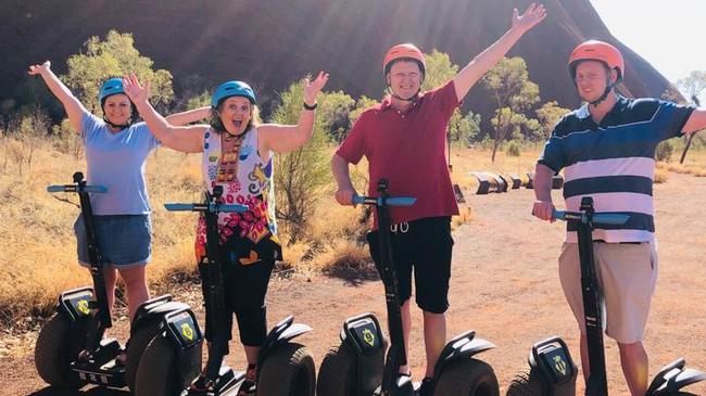 Travel guides the Fren family on segways at Uluru.