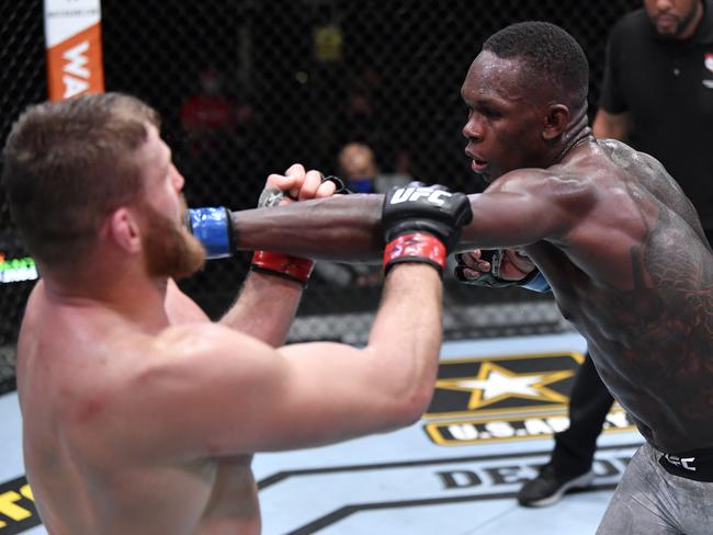 LAS VEGAS, NEVADA - MARCH 06: In this handout image provided by UFC, (R-L) Israel Adesanya of Nigeria punches Jan Blachowicz of Poland in their UFC light heavyweight championship fight during the UFC 259 event at UFC APEX on March 06, 2021 in Las Vegas, Nevada. (Photo by Jeff Bottari/Zuffa LLC via Getty Images)