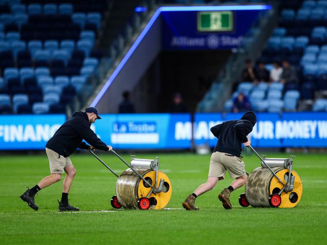 Ground staff were busy trying to remove water off the surface at Allianz Stadium on Friday night. Credit: NRL Images.