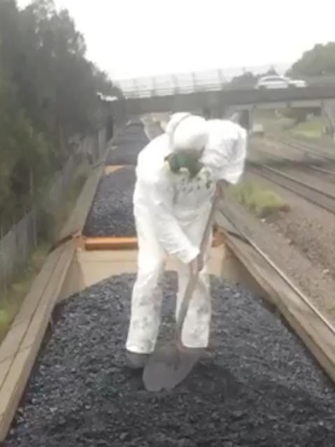 “Zelda” on top of a coal train in a hazmat suit. Picture: Facebook/Blockade Australia