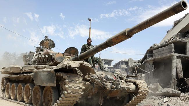 Syrian Army soldiers advancing in an area on the eastern outskirts of Douma. Picture: AFP