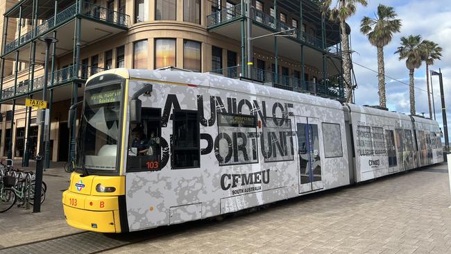 An Adelaide tram at Glenelg with the CFMEU advertising. Picture: Jo Schulz