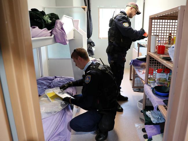 Prison officers search a cell at John Moroney Correctional Centre in Windsor Photo: Tim Hunter.