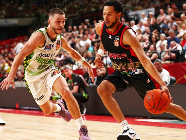 Tyler Harvey of the Hawks drives to the basket under pressure from Ben Ayre.