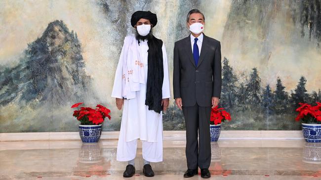 China’s Foreign Minister Wang Yi, right, meets Taliban political chief Mullah Abdul Ghani Baradar in Tianjin in July. Picture: Xinhua.