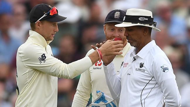 England captain Joe Root holds up the ball for umpire Joel Wilson to smell during day four of the first Ashes Test. Picture: Gareth Copley/Getty Images