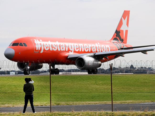 SYDNEY, AUSTRALIA - NewsWire Photos,July 16, 2022: A young family watch planes prepare for take-off from the external fences at SydneyÃs Domestic Airport.Picture: NCA NewsWire / Jeremy Piper