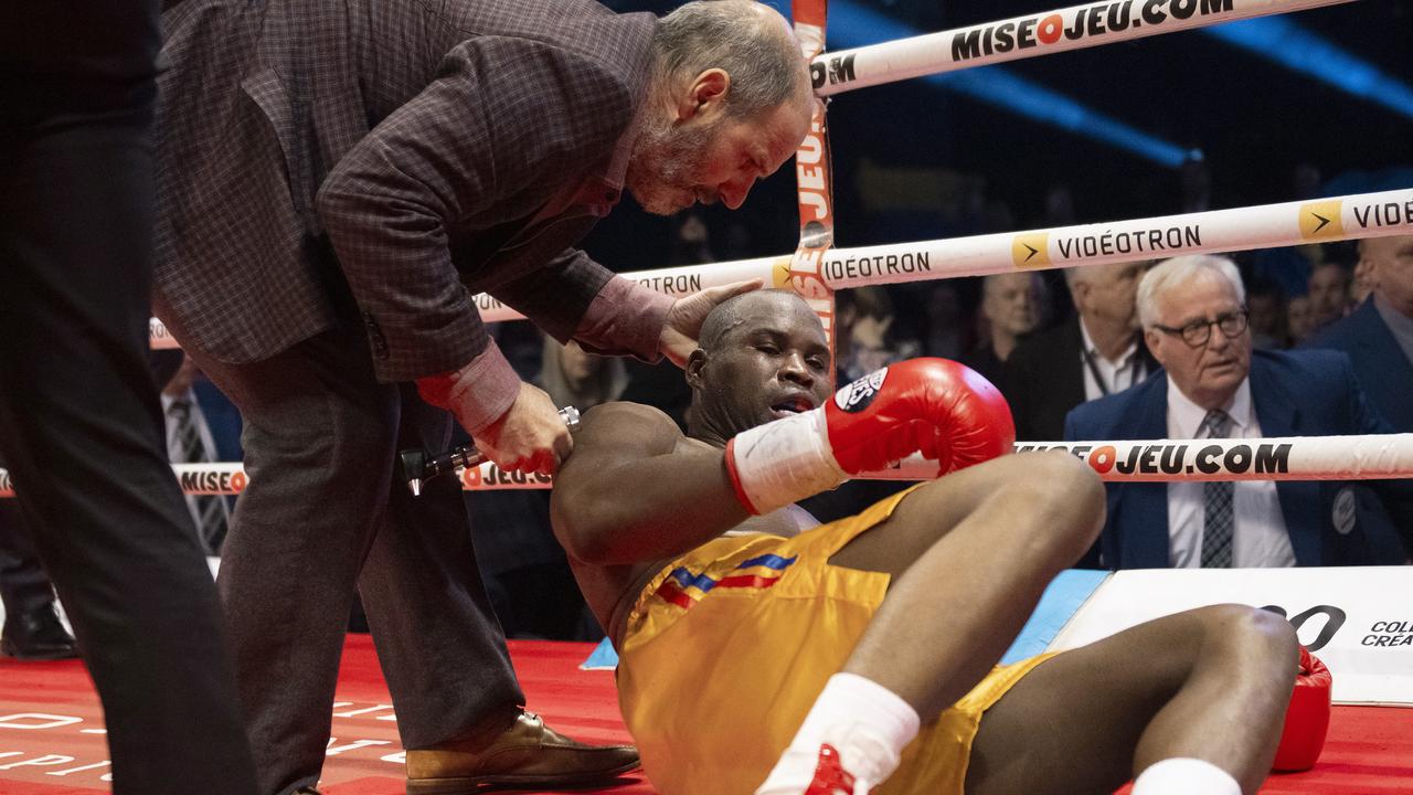 Ring doctor Marc Gagne checks on Adonis Stevenson after he was knocked out by Oleksandr Gvozdyk. (Jacques Boissinot/The Canadian Press via AP)