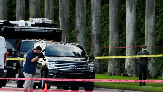 An FBI agent takes picture of the evidence of the crime scene outside the Trump International Golf Club in West Palm Beach, Florida. Picture: AFP