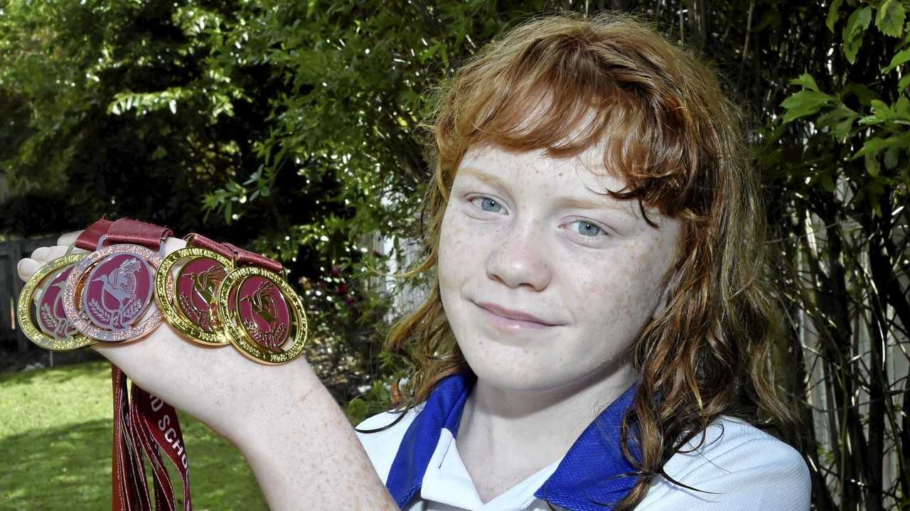 ATHLETIC STAR: Megan Seipel, 11, proudly shows off the medals she won at last weekend's 10-12 years Track and Field State Championships in Cairns. Picture: Bev Lacey