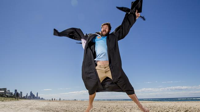 Gold Coast Titan Anthony Don has just got his masters degree. Anthony at Nobby Beach with Surfers Paradise skyline in the background. Picture: Jerad Williams