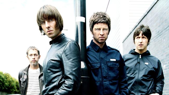 Singer Liam Gallagher (L) and his musician brother Noel stand in front of fellow members of band 'Oasis'. Pic Sony BMG.