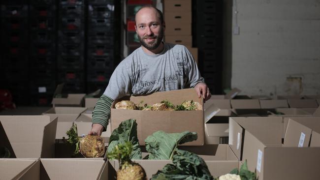 BYLINE - LUKE BOWDEN: Greg Woodward from Backyard Bounty packing fresh vegetables for his customers.