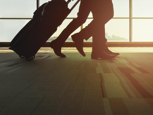 ESCAPE: Travel story on Frequent Flyer credits and airline loyalty point programs. By Lisa Mayoh. iStockSilhouette traveller with luggage walking in the airport