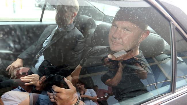 Jason Trouchet (right) with police at Coolangatta Airport.