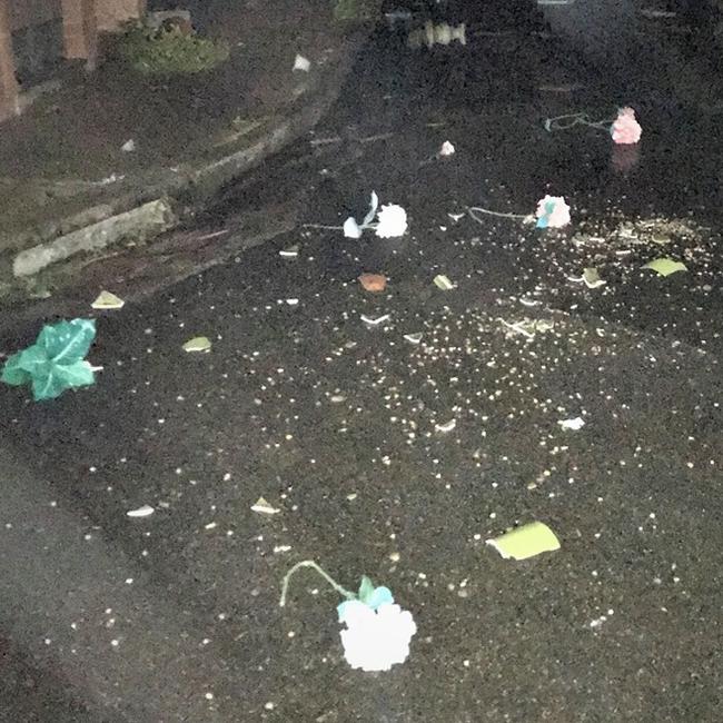 The smashed remains of memorial vases were scattered across a roadway. Picture: NSW Police