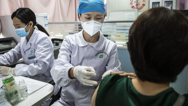 A medical worker administers a dose COVID-19 vaccine in Wuhan. Picture: Getty Images.