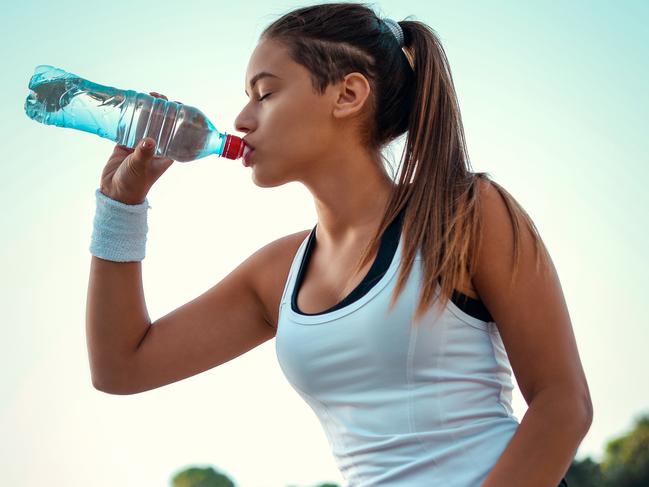 A Girl Drinking Water after exercise