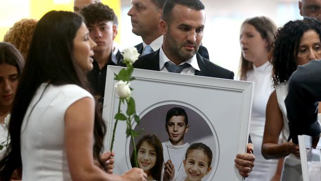 The Abdallah family at a mass at Our Lady of Lebanon church in Harris Park on Friday night. Picture: Damian Shaw