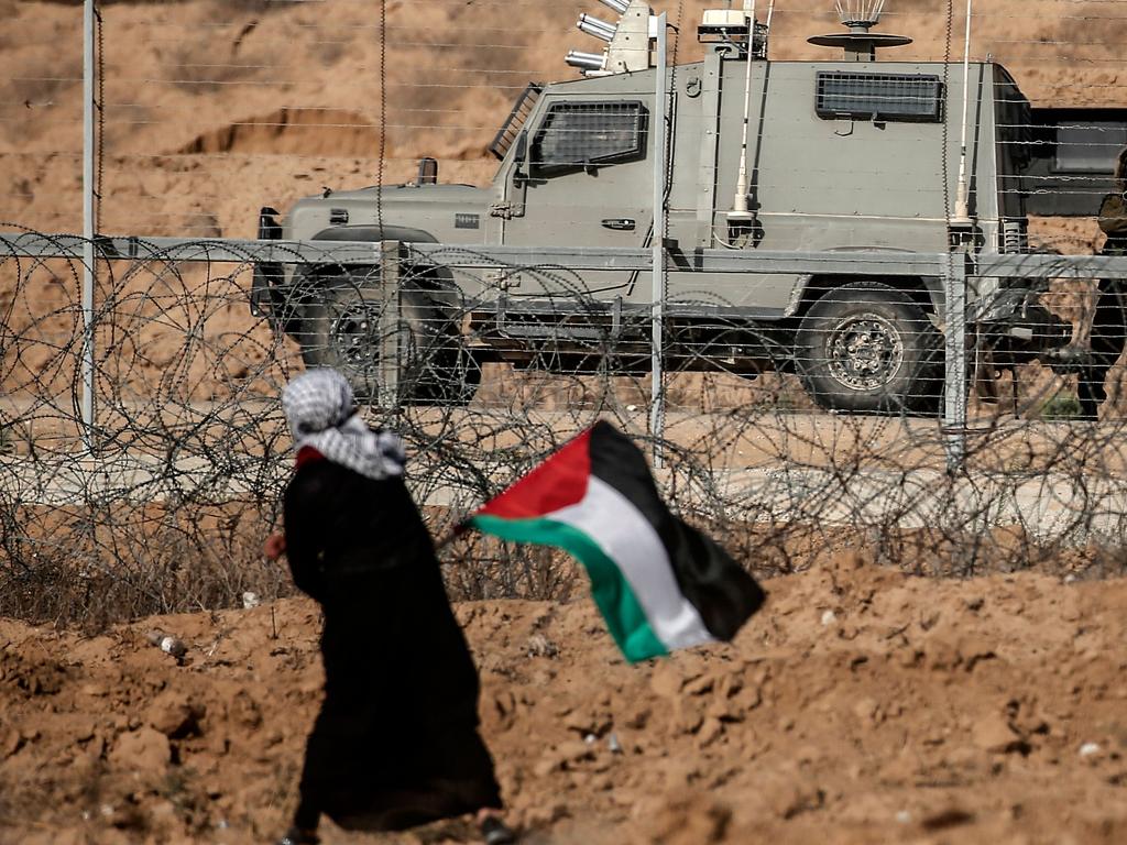 An Israeli security forces officer aims at a Palestinian demonstrator during protests along the border with Israel, east of Khan Yunis, in the southern Gaza Strip on July 12, 2019. Picture: AFP