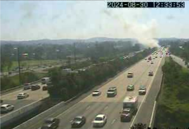 View of the fire from the M1 traffic camera at Helensvale. Picture: TMR