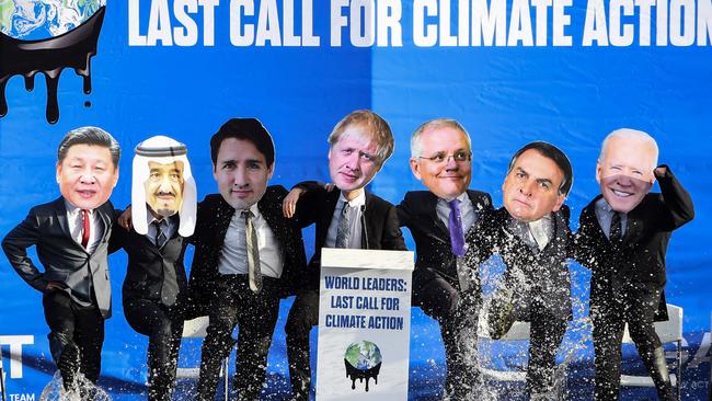 Climate change activists dressed as world leaders, including from left, China’s President Xi Jinping, Saudi Arabia's King Salman bin Abdulaziz, Canada's Prime Minister Justin Trudeau, Britain's Prime Minister Boris Johnson, Australia's Prime Minister Scott Morrison, Brazil's President Jair Bolsonaro, and US President Joe Biden, pose for a photograph during a demonstration in the Forth and Clyde Canal in Glasgow during the COP26 UN Climate Change Conference. Picture: AFP