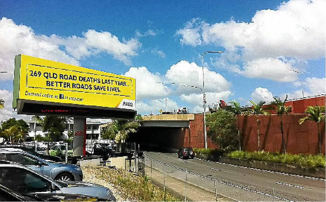 SIGN LANGUAGE: An RACQ billboard on road safety appears on the Bruce Highway demanding action from the major political parties on urgent road funding. Picture: DARREN CARTWRIGHTAAP