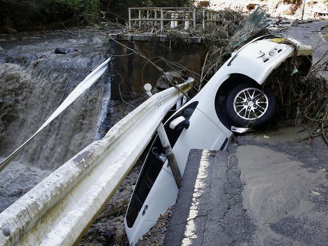 A vehicle falls off collapsed road in the typhoon-hit Kakuda city, Miyagi prefecture, northern Japan. Picture: Kyodo News via AP