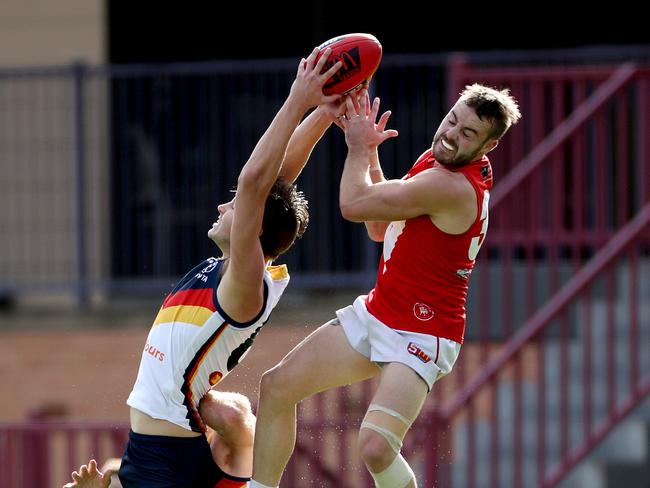 Davey takes a hanger against North Adelaide’s Max Thring. Picture: Calum Robertson