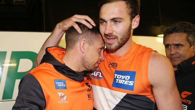 Brett Deledio hugs teammate Jeremy Finlayson after game . Pic: Michael Klein.