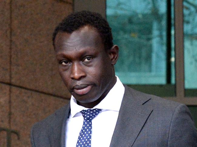 MELBOURNE, AUSTRALIA - NewsWire Photos JUNE 21, 2022: AFL footballer Majak Daw leaves the Melbourne Magistrates Court after receiving a fine for driving an unregistered vehicle. Picture: NCA NewsWire / Andrew Henshaw