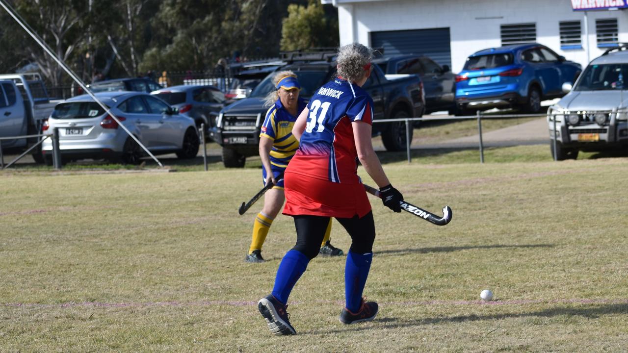 Celene Keleher running the ball down the line in Warwick's game against Townsville at the 2021 Queensland Hockey Women's Masters Championship at Queens Park.