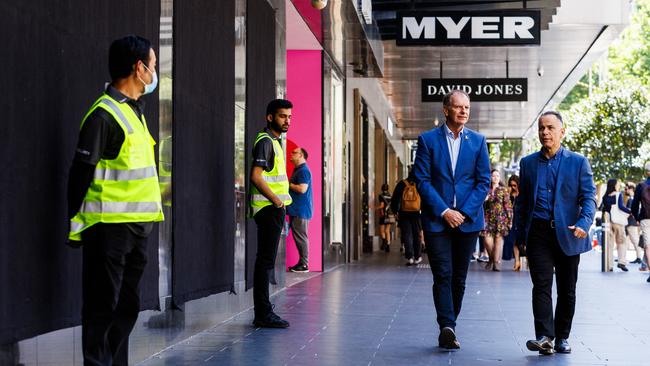 Victorian Opposition Leader John Pesutto and deputy leader David Southwick walk past security stationed in front of the Myer Christmas windows. Picture: NewsWire/Aaron Francis