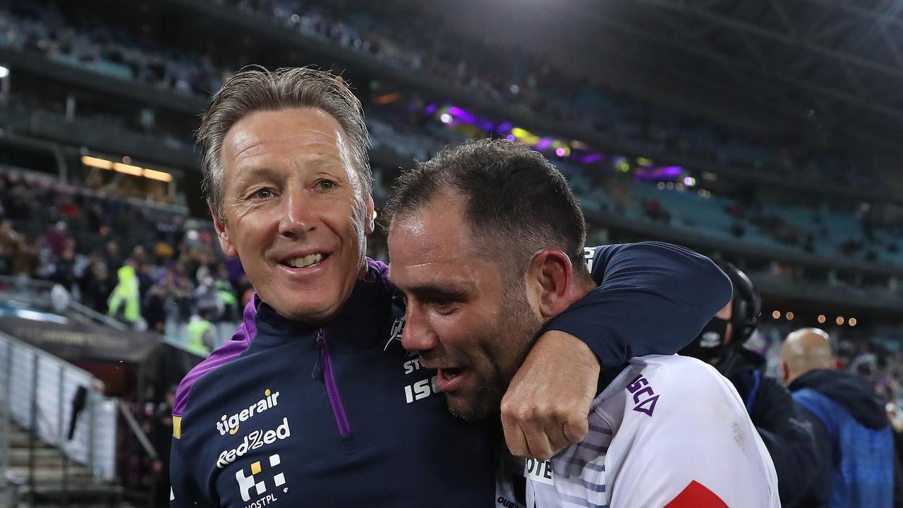 Melbourne coach Craig Bellamy celebrates victory with Cameron Smith.