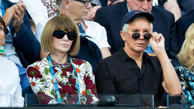 Anna Wintour (left) and Australian film director Baz Luhrmann, right, in the crowd during the men's singles quarterfinals match between Novak Djokovic of Serbia and Kei Nishikori of Japan.