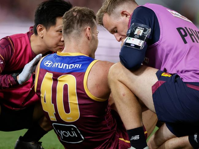 BRISBANE, AUSTRALIA - SEPTEMBER 07: Jack Payne of the Lions is seen in the hands of trainers during the 2024 AFL First Elimination Final match between the Brisbane Lions and the Carlton Blues at The Gabba on September 07, 2024 in Brisbane, Australia. (Photo by Russell Freeman/AFL Photos via Getty Images)