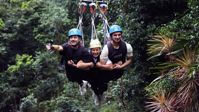 World Para Surfing champion Sam Bloom has visited Skypark Cairns while on a family holiday with her husband and sons, to show that inclusive travel is possible in Far North Queensland's World Heritage regions and award-winning attractions. Sam Bloom (centre) rides the giant swing at Skypark with 2 of her 3 sons Oli Bloom and Noah Bloom. Picture: Brendan Radke