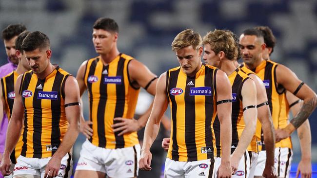 Hawthorn players trudge off GMHBA Stadium after being blown away by Geelong.