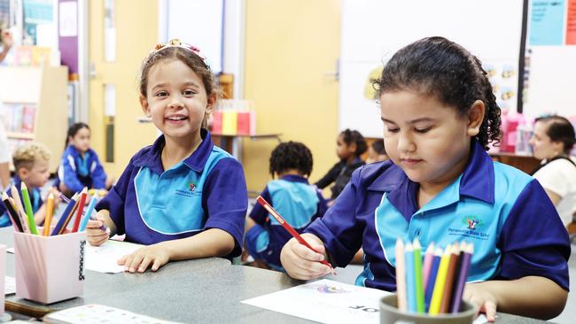 Parramatta State School prep student Ezra Booysen does some colouring in with her new friend Teana Foley on the first day of school for 2025. Picture: Brendan Radke