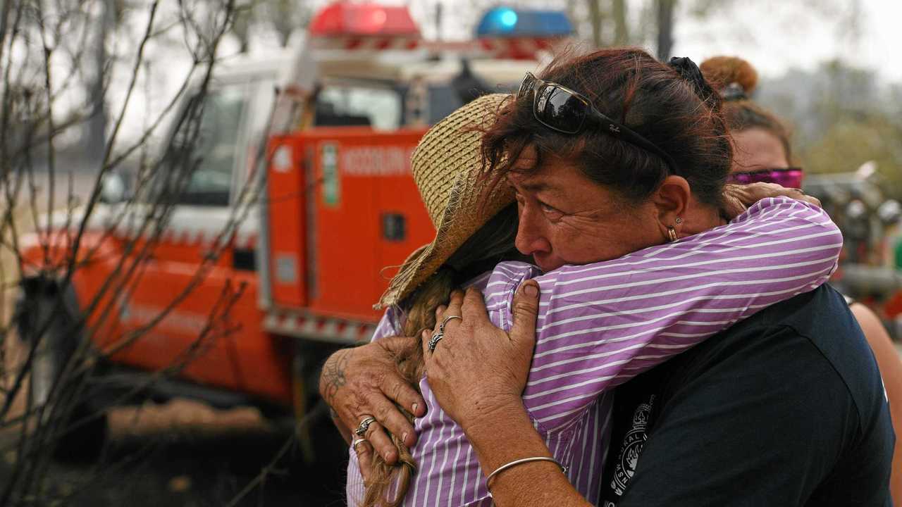 Bora Ridge resident Clare Barry embraces Rural Fire Fighter Raelene Davis after Raelene and her daughter Chantelle helped save the property and horses. Picture: Marc Stapelberg